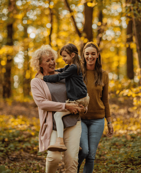 3 gen of women walking through forest